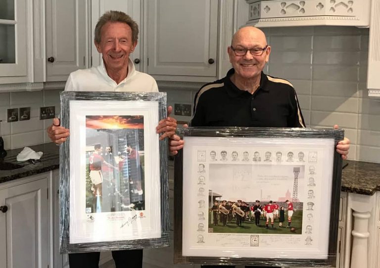 Denis Law and Alan Wardle with paintings for charity auction